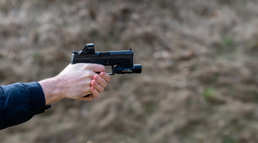 The shooter aims with a gun in his hand