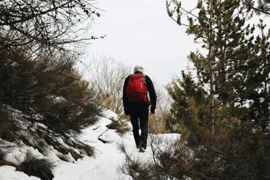 A man, winter, outdoors, red backpack